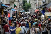 People, mainly tourists, throng a street in the Montmartre district of Paris, Aug. 9, 2019 (AP photo by Lewis Joly).