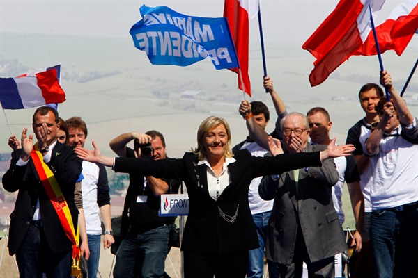 Marine Le Pen, center, far-right National Front candidate for France’s 2012 presidential election,  with her father Jean Marie Le Pen, right, after her speech during the traditional May Day march in Paris, May 1, 2012 (AP photo by Francois Mori).