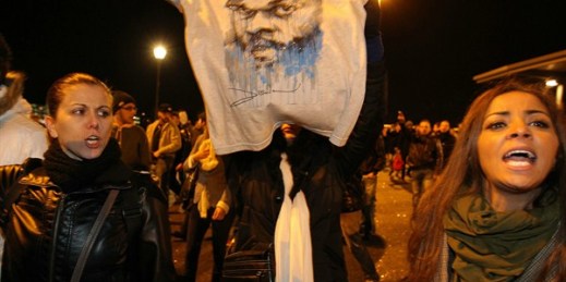 A supporter of French comic Dieudonne Mbala Mbala displays a t-shirt with his image, Nantes, France, Jan. 9, 2014 (AP photo by David Vincent).