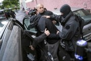 French police officers detain a suspected jihadists during a raid in Strasbourg, France, May 13, 2014 (AP photo by Jean Francois Badias).