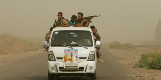 Iraqi Shiite fighters with the "Peace Brigades" patrol during a sand storm in Samarra, Iraq, July 12, 2014 (AP Photo/File).