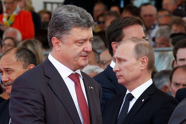 Ukrainian then-President-elect Petro Poroshenko and Russian President Vladimir Putin Ouistreham, France, June 6, 2014 (AP photo by Christophe Ena, Pool).