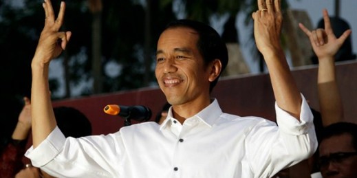 Indonesian President-elect Joko Widodo greets supporters with his "three-finger greeting" symbolizing the unity of Indonesia, Jakarta, Indonesia, July 23, 2014 (AP photo by Dita Alangkara).