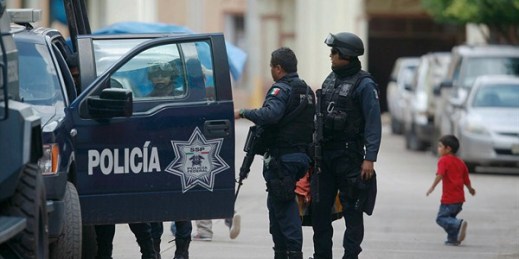 Mexican federal police stand next to their vehicle in the town of Aguililla, Mexico, July 24, 2013 (AP photo by Gustavo Aguado).