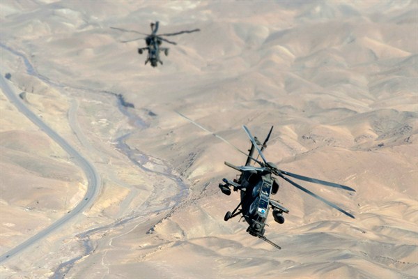 Two A-129 Mangusta helicopters fly over an unknown location in Afghanistan, Sept. 8, 2013 (AP photo courtesy of the Italian Army Public Affairs Office in Herat).