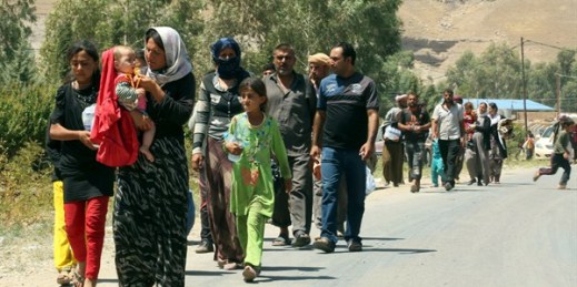 Displaced Iraqis from the Yazidi community cross the Syria-Iraq border at Feeshkhabour border point, in northern Iraq, Aug. 10, 2014 (AP photo by Khalid Mohammed).