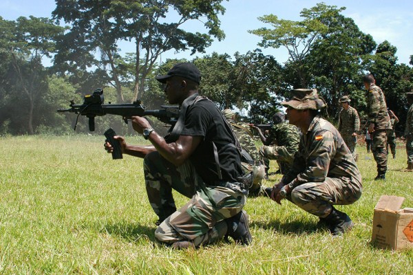 Spanish Marine Sgt. Cole Mulbah Ruiz watches as members of Cameroonian Rapid Intervention Battalion practice their marksmanships skills, April 6, 2009 (U.S. Marine Corps photo by Sgt. Elsa Portillo).