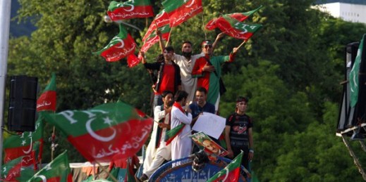 Supporters of Pakistan's cricketer-turned-politician Imran Khan wave party flags as they chant slogans during a protest near the prime minister's home in Islamabad, Pakistan, Sept. 2, 2014 (AP photo by Anjum Naveed).