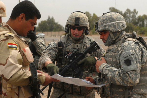 U.S. Army 1st Lt. Andrew Dacey reviews security checkpoints with Iraqi soldiers in the city of Abu Ghraib, Iraq, March 31, 2009 (U.S. Army photo).