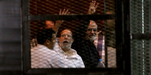 Senior Muslim brotherhood leader Essam el-Erian and their spiritual leader Mohammed Badie appear in a courtroom cage in Cairo, Egypt, Aug. 30, 2014 (AP photo by Mohammed Abu Zeid).