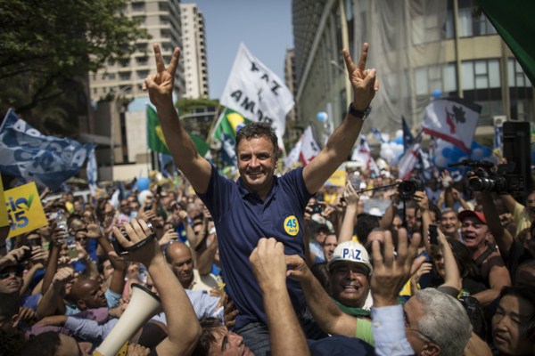 Aecio Neves, Brazilian Social Democracy Party presidential candidate, greets supporters while campaigning at Copacabana beach in Rio de Janeiro, Brazil, Oct. 19, 2014 (AP photo by Felipe Dana).