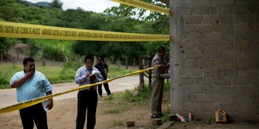 State authorities seal off a warehouse that was the site of a shootout between Mexican soldiers and alleged criminals on the outskirts of San Pedro Limon (AP photo by Rebecca Blackwell).
