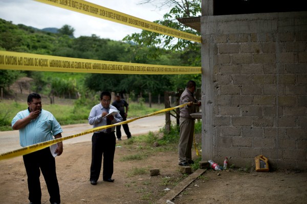 State authorities seal off a warehouse that was the site of a shootout between Mexican soldiers and alleged criminals on the outskirts of San Pedro Limon (AP photo by Rebecca Blackwell).
