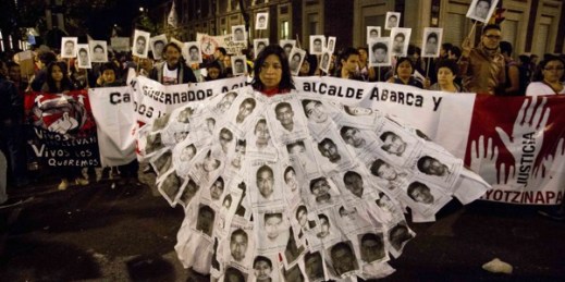 A woman marches with leaflets with the images of missing students attached to her body, during a protest against the disappearance of 43 students from the Isidro Burgos rural teachers college, in Mexico City, Oct. 22, 2014 (AP photo by Eduardo Verdugo).