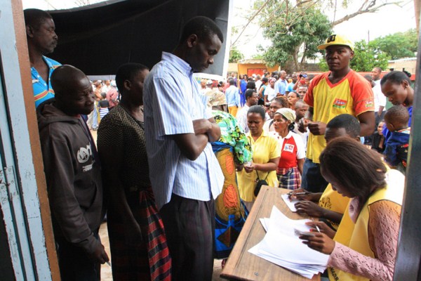 Voters produce identity documents as they go through the voting process at a polling station in Maputo, Mozambique, Oct. 15, 2014 (AP photo by Ferhat Momade).
