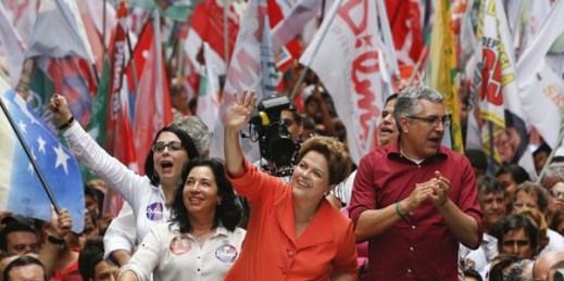 Brazilian President Dilma Rousseff flanked by Workers Party Sao Paulo gubernatorial candidate Alexandre Padilha waves to supporters during a campaign rally in Santos, Brazil, Sept. 30, 2014 (AP photo by Andre Penner).