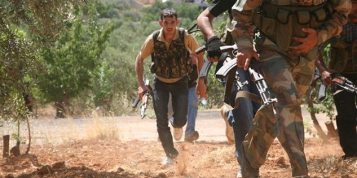 Syrian rebels from the “Al-Qasas Brigade” or “Justice Brigade” run through an olive grove to avoid Syrian Army snipers, Oct. 20, 2012 (photo by Flickr user syriafreedom licensed under the Creative Commons Attribution 2.0 Generic license).