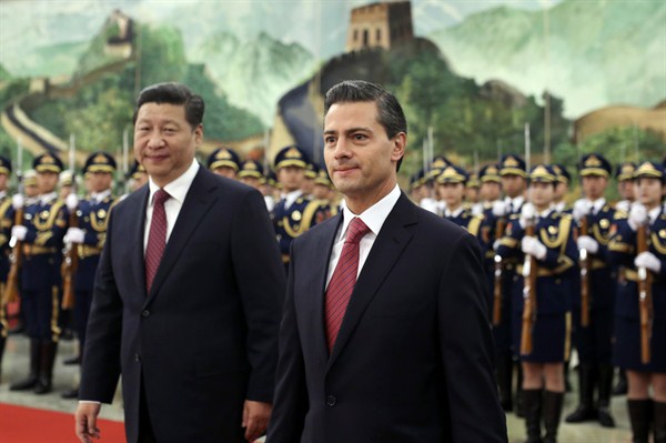 Mexican President Enrique Pena Nieto walks with Chinese President Xi Jinping during a welcome ceremony at the Great Hall of the People in Beijing, Nov. 13, 2014 (AP photo by Andy Wong).