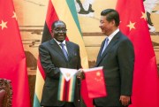 Zimbabwean President Robert Mugabe and Chinese President Xi Jinping shake hands during a signing ceremony at the Great Hall of the People in Beijing, China, Aug. 25, 2014 (AP photo by Diego Azubel).