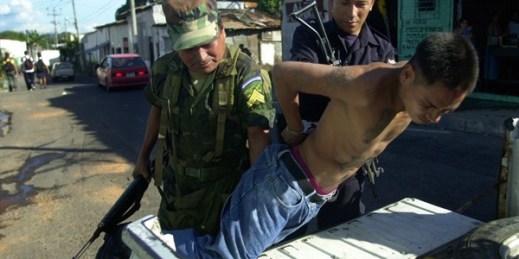A police officer and a soldier arrest a gang member in compliance with the government’s “Mano Dura” plan in San Salvador, El Salvador, Oct. 16, 2003 (AP photo by Victor Ruiz Caballero).