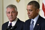 Defense Secretary Chuck Hagel listens as President Barack Obama talks about Hagel’s resignation during an event in the State Dining Room of the White House in Washington, Nov. 24, 2014 (AP photo by Susan Walsh).