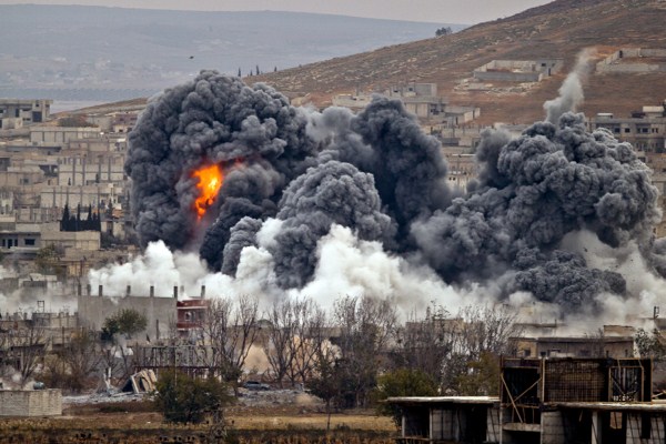 Smoke rises from the Syrian city of Kobani, following an airstrike by the U.S.-led coalition, seen from a hilltop outside Suruc, on the Turkey-Syria border, Nov. 17, 2014 (AP photo by Vadim Ghirda).