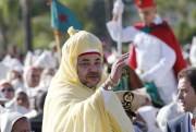 Moroccan King Mohammed VI waves to the crowd as he stands in a limousine during a ceremony of allegiance, at the king’s palace in Rabat, Morocco, July 31, 2014 (AP photo by Abdeljalil Bounhar).