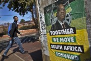 A man walks past an election poster of Jacob Zuma’s African National Congress (ANC) party in the Soweto township of Johannesburg, South Africa, May 9, 2014 (AP photo by Ben Curtis).