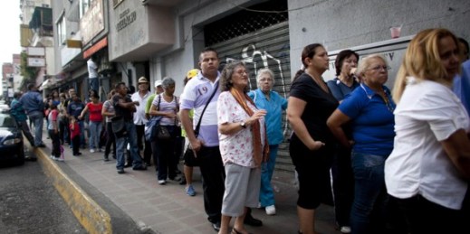 People wait in line to enter a small market to try to buy items like disposable diapers, laundry detergent and razors in downtown Caracas, Venezuela, Oct. 23, 2014 (AP photo by Ariana Cubillos).