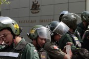 Cambodian riot police officers stand guard in front of Australian Embassy in Phnom Penh, Cambodia, Sept. 26, 2014 (AP photo by Heng Sinith).