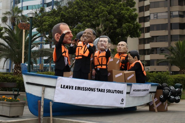 Environmental activists in a boat perform wearing puppet heads representing world leaders during the Climate Change Conference COP20 in Lima, Peru, Dec. 12, 2014 (AP photo by Martin Mejia).