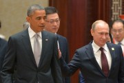Russian President Vladimir Putin passes by U.S. President Barack Obama at the Asia-Pacific Economic Cooperation (APEC) Summit, Beijing, China, Nov. 11, 2014 (AP Photo/RIA Novosti).