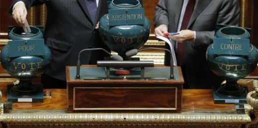 A French Senator casts his ballot in an urn supporting a motion, at left, during a vote on the recognition of a Palestinian state, at the French Senate in Paris, France, Dec. 11, 2014 (AP photo by Francois Mori).
