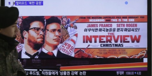 A South Korean army soldier walks near a TV screen showing an advertisement for Sony Pictures’ “The Interview,” at the Seoul Railway Station in Seoul, South Korea, Dec. 22, 2014 (AP photo by Ahn Young-joon).
