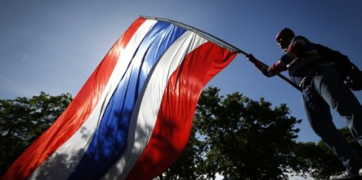 An anti-government protester waves a Thai national flag during a rally in downtown Bangkok, Thailand, May 9, 2014 (AP photo by Vincent Thian).