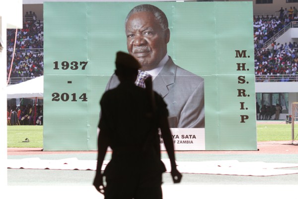 An armed soldier enters the stadium where the coffin of the late Zambian President Michael Sata was draped in Zambia’s flag at the funeral in Lusaka, Nov, 11, 2014 (AP photo by Tsvangirayi Mukwazhi).