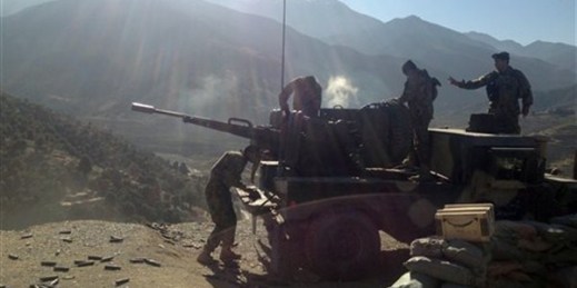Afghan National Army soldiers open fire into mountains during an ongoing war in the Dangam district of Kunar province, Afghanistan, Dec. 28, 2014 (AP photo by Rahim Faiez).