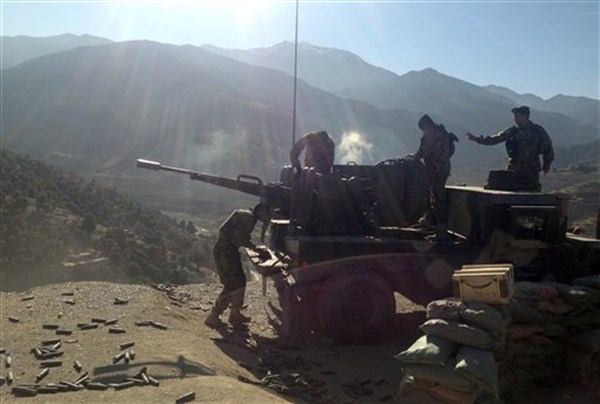 Afghan National Army soldiers open fire into mountains during an ongoing war in the Dangam district of Kunar province, Afghanistan, Dec. 28, 2014 (AP photo by Rahim Faiez).