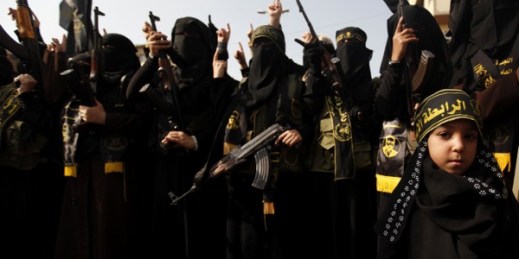 Palestinian female militants of the Islamic Jihad hold their weapons during a rally marking the 26th anniversary of the movement’s foundation in Gaza City, Nov. 1, 2013 (AP photo by Hatem Moussa).