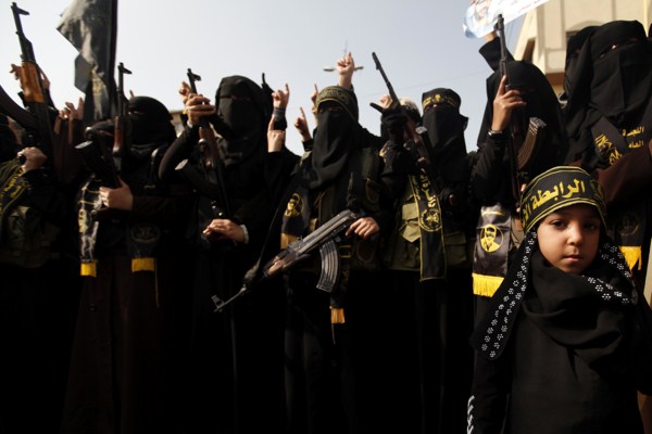 Palestinian female militants of the Islamic Jihad hold their weapons during a rally marking the 26th anniversary of the movement’s foundation in Gaza City, Nov. 1, 2013 (AP photo by Hatem Moussa).