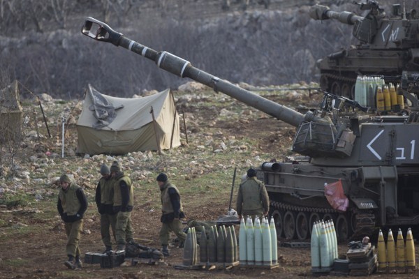 Israeli soldiers stand next to a mobile artillery unit in the Israeli-controlled Golan Heights near the border with Syria, Jan. 28, 2015 (AP photo by Ariel Schalit).