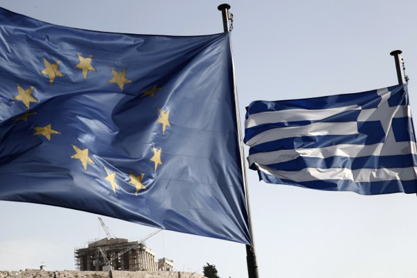 The flags of Greece and the European Union billow in the wind in front of the ruins of the fifth century B.C. Parthenon temple, Athens, Greece, Jan. 23, 2015 (AP photo by Petros Giannakouris).