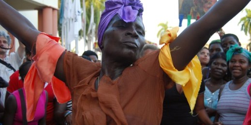 A woman dances to Gaga Afro-Caribbean music during a protest against racial discrimination and “denationalization” of Dominicans of Haitian descent, Santo Domingo, Dominican Republic, March 21, 2014 (AP photo by Ezequiel Abiu Lopez).