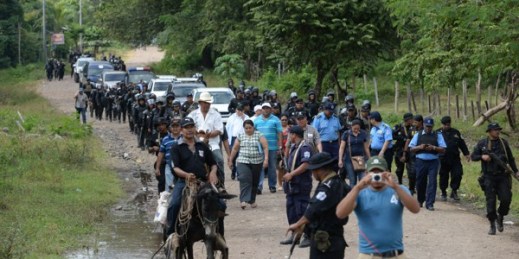 Riot police enter the town of El Tule, Nicaragua after they cleared a roadblock erected by residents to protest against a proposed transoceanic canal, Dec. 24, 2014 (AP photo by Oscar Navarrete).