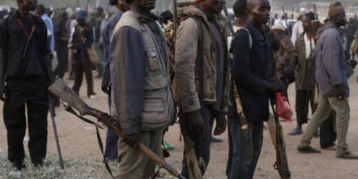 Vigilante and local hunters armed with locally made guns gather before a patrol to protect their town from Boko Haram gunmen, Yola, Nigeria, Nov. 25, 2014 (AP photo by Sunday Alamba).