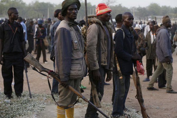 Vigilante and local hunters armed with locally made guns gather before a patrol to protect their town from Boko Haram gunmen, Yola, Nigeria, Nov. 25, 2014 (AP photo by Sunday Alamba).