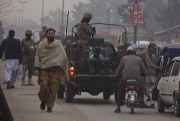 Pakistani army soldiers check vehicles near the Army Public School which was targeted by Taliban militants last year, Peshawar, Pakistan, Jan. 12, 2015 (AP photo by B.K. Bangash).