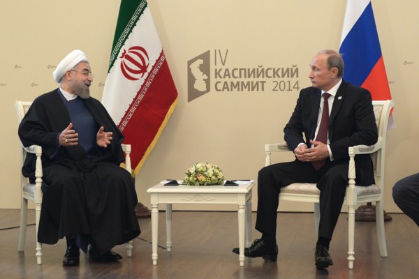 Iranian President Hassan Rouhani and Russian President Vladimir Putin speak during their meeting at the Caspian Summit in Astrakhan, Russia, Sept. 29, 2014 (AP Photo/RIA Novosti, Alexei Nikolsky).