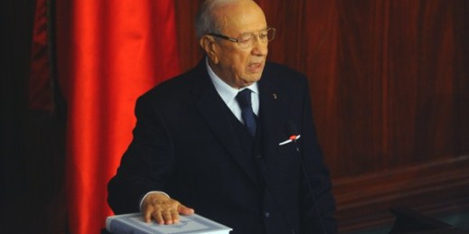 Beji Caid Essebsi puts his hand on the Quran to be sworn in as Tunisia’s president during a ceremony at the National Assembly in Tunis, Dec. 31, 2014 (AP photo by Hassene Dridi).