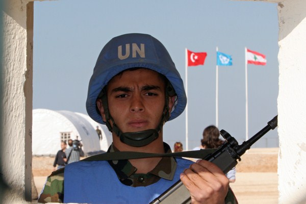A Turkish member of the U.N. peacekeeping force in Lebanon (UNIFIL) stands in his sentry box at the entrance of the Turkish Engineer Construction Company stationed near the southern port city of Tyre, Nov. 16, 2006 (AP photo by Burhan Ozbilici).